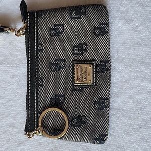 D&B wristlet trimmed in leather. Monogram pattern. Used but good conditio